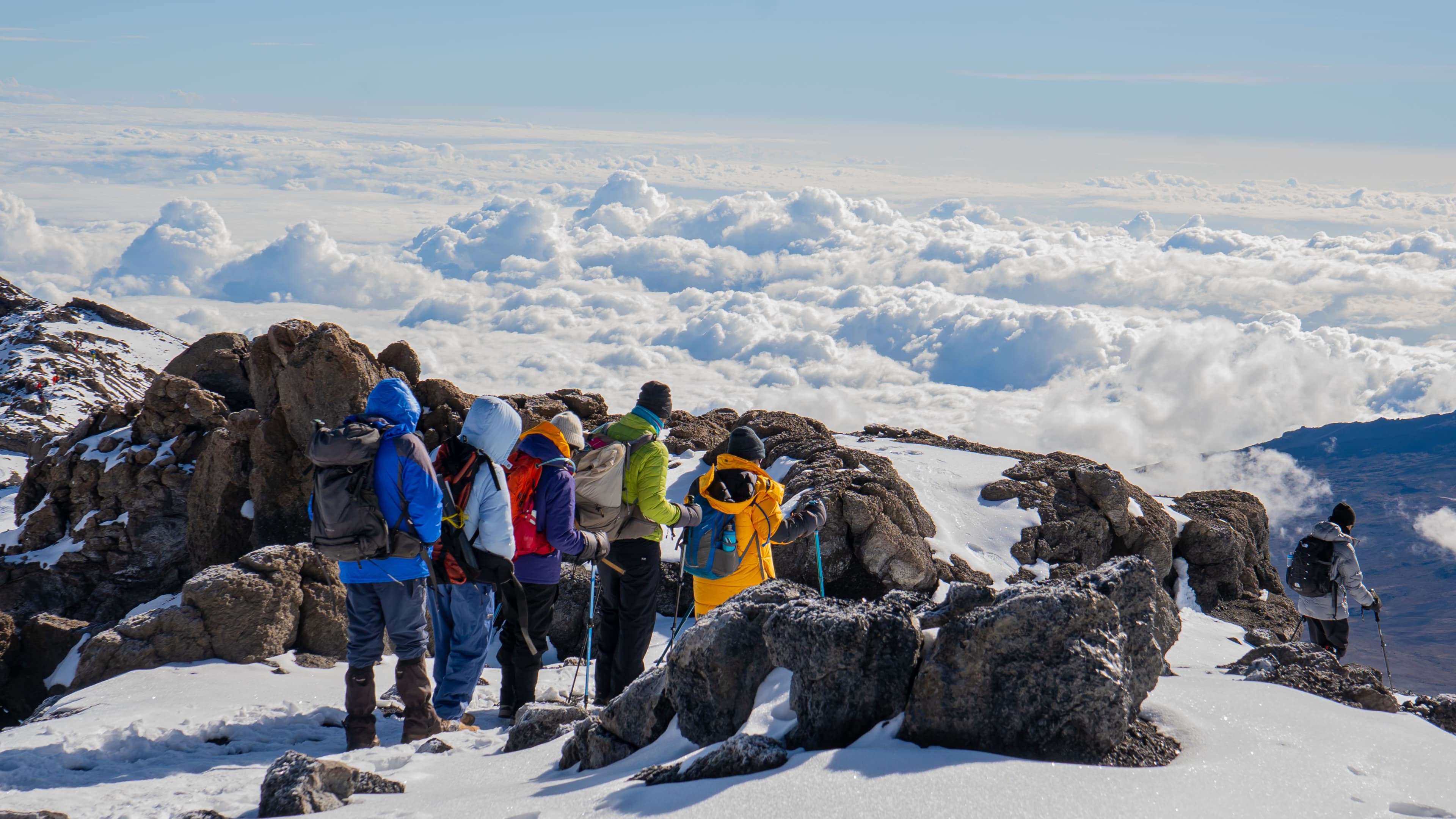 Climbers pausing above Kilimanjaro's cloud line