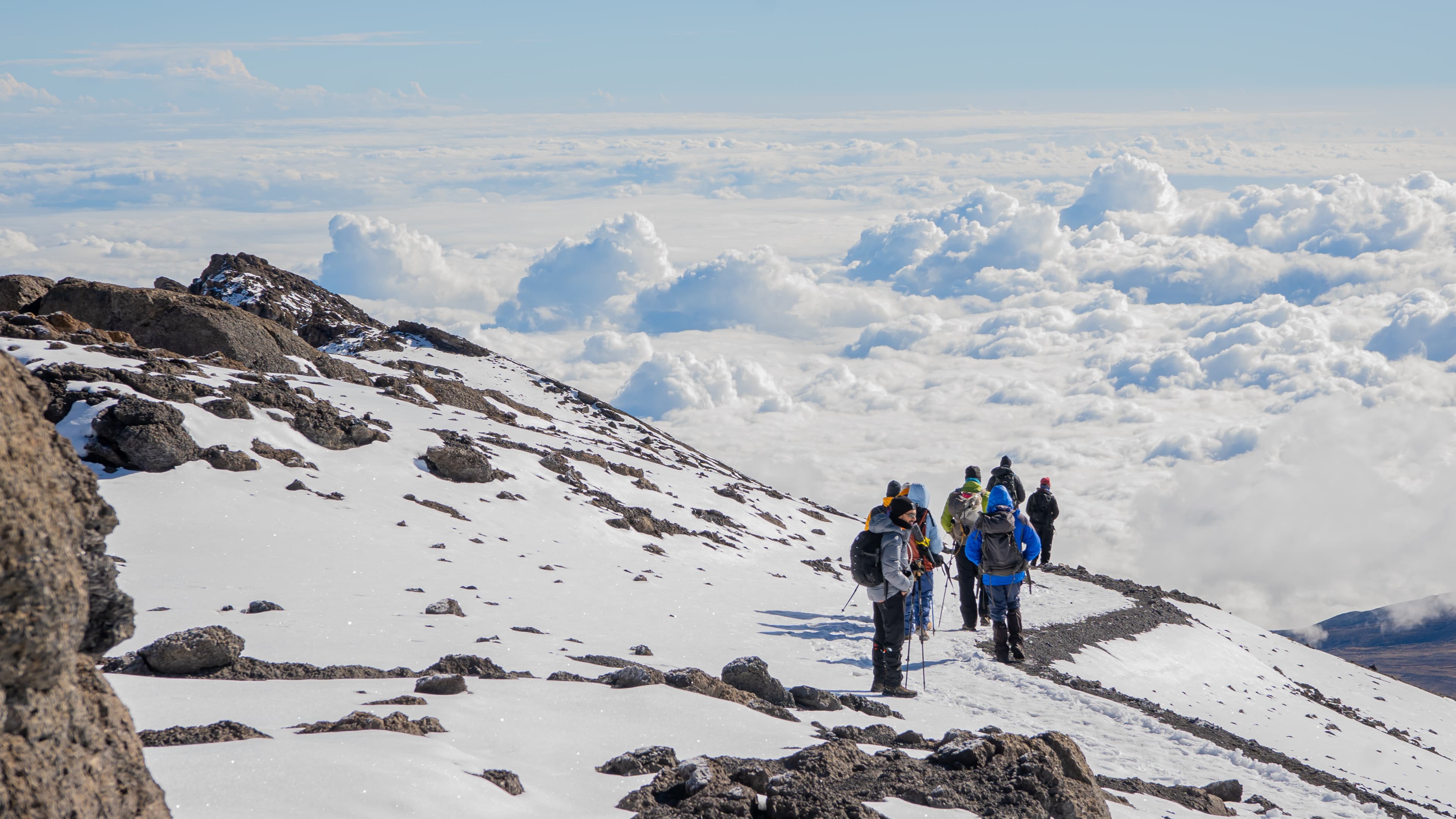Climbers crossing a snow-covered Kilimanjaro slope