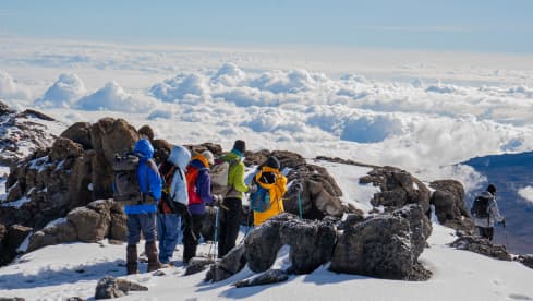 Climbers resting above the clouds